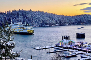 A cruise ship floating near a dock in winter