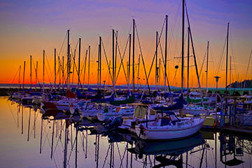A dock filled with boats at dawn