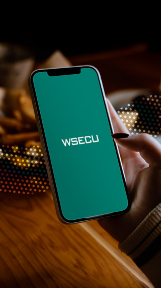 a smartphone displaying a teal screen with "WSECU" written across the middle in white