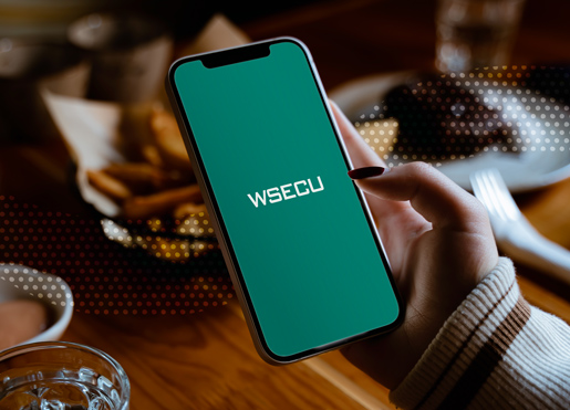 a smartphone displaying a teal screen with "WSECU" written across the middle in white