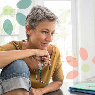 Woman smiling while holding eyeglasses