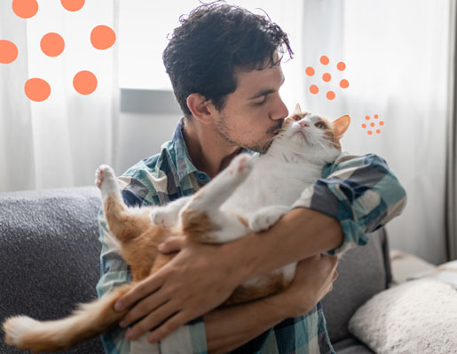 A man kissing a cat