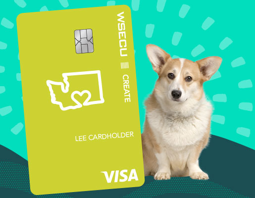 A corgi sitting next to a giant WSECU Create Visa card