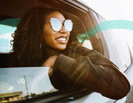 woman leaning out car window smiling