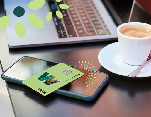 WSECU Create visa set on top of a mobile phone next to a cup of coffee