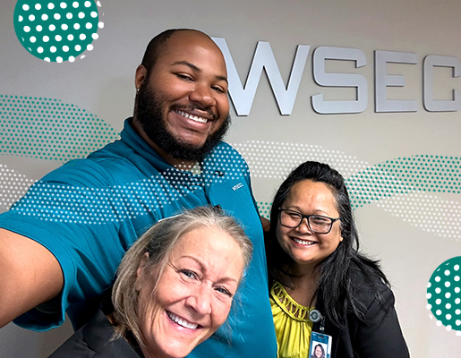 Three WSECU employees posing and smiling