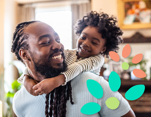 Indoor scene of an adult giving a piggyback ride to a child.