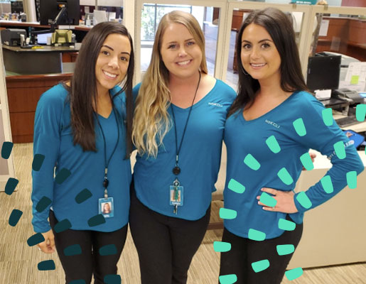 Three WSECU employees posing and smiling