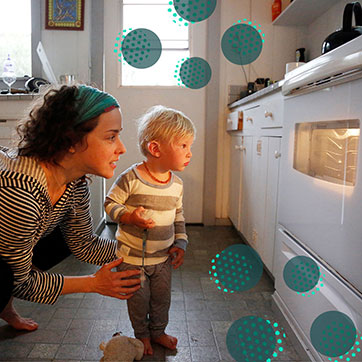 Mother and child looking through an oven window