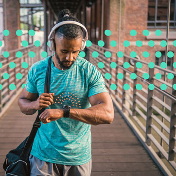 a man leaving the gym looking down at his smart watch