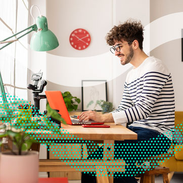 a man sitting at a desk on his laptop