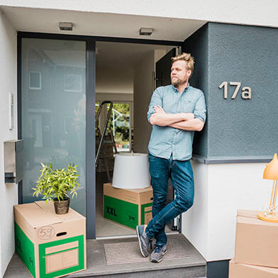 Man leaning against apartment wall