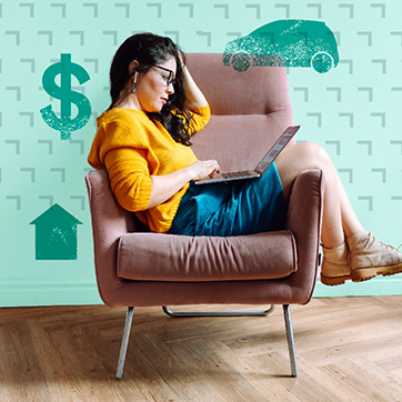 Woman looking at laptop while sitting on a chair