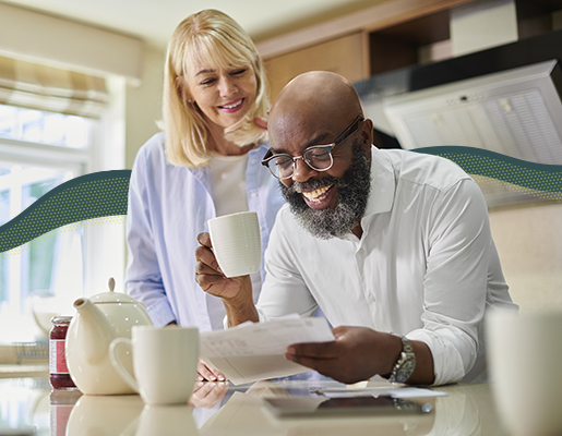 A couple looking at account statements while having coffee