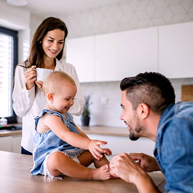 Couple playing with baby in kitchen