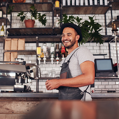 Man smiling while working at coffe shop
