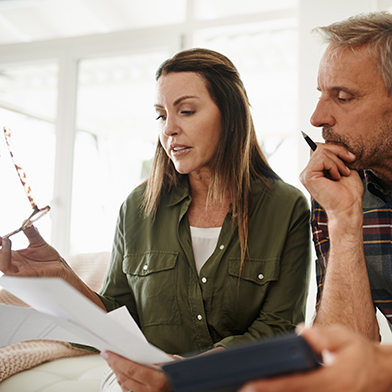 Woman and man talking while looking at piece of paper