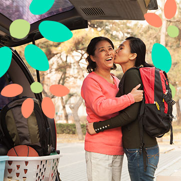 College-aged woman kissing her mother on the cheek