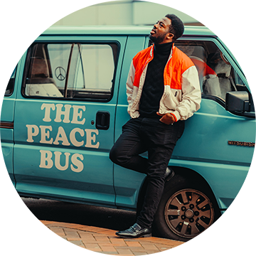 Kwabi Amoah-Forson leaning on the Peace Bus