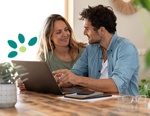 Couple staring at each other while in front of a laptop