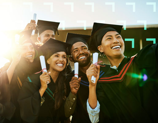 A group of graduates holding up their diplomas, smiling