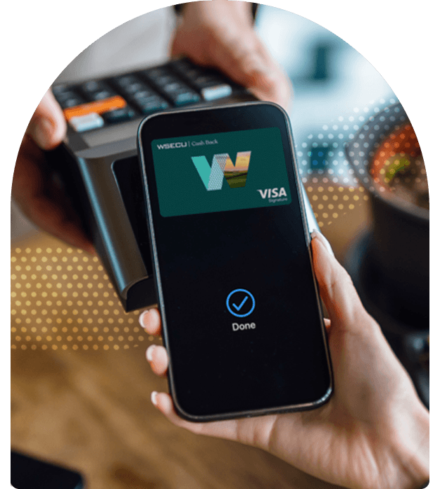 Mobile wallet payment confirmation displayed on a smartphone beside a point-of-sale terminal.