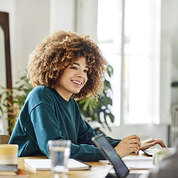 A woman sitting at a laptop