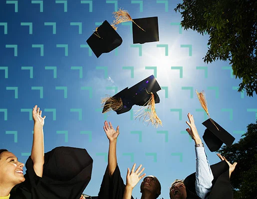Graduation hats being thrown in the air